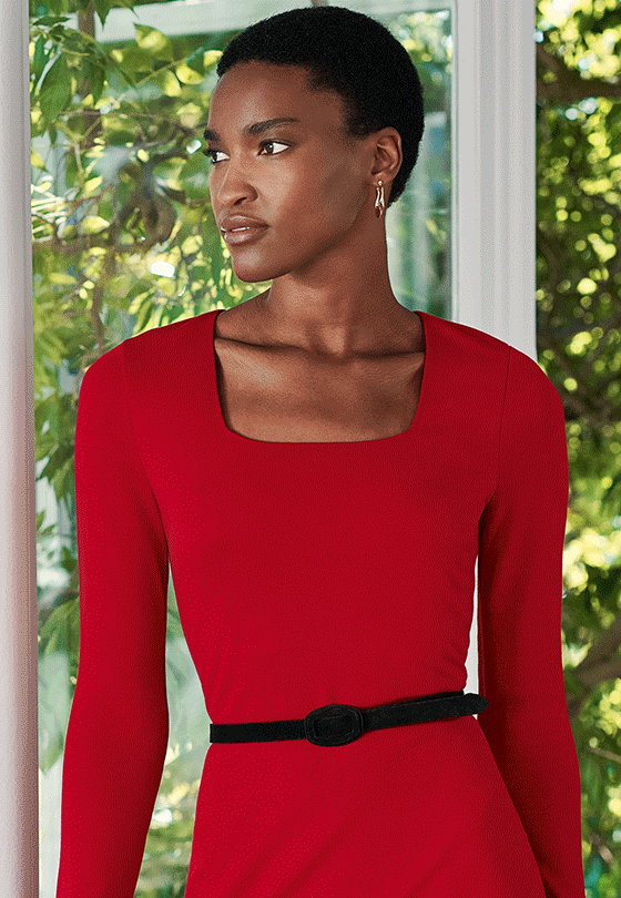 Close-up showing the neckline of a Hobbs red dress on a model.