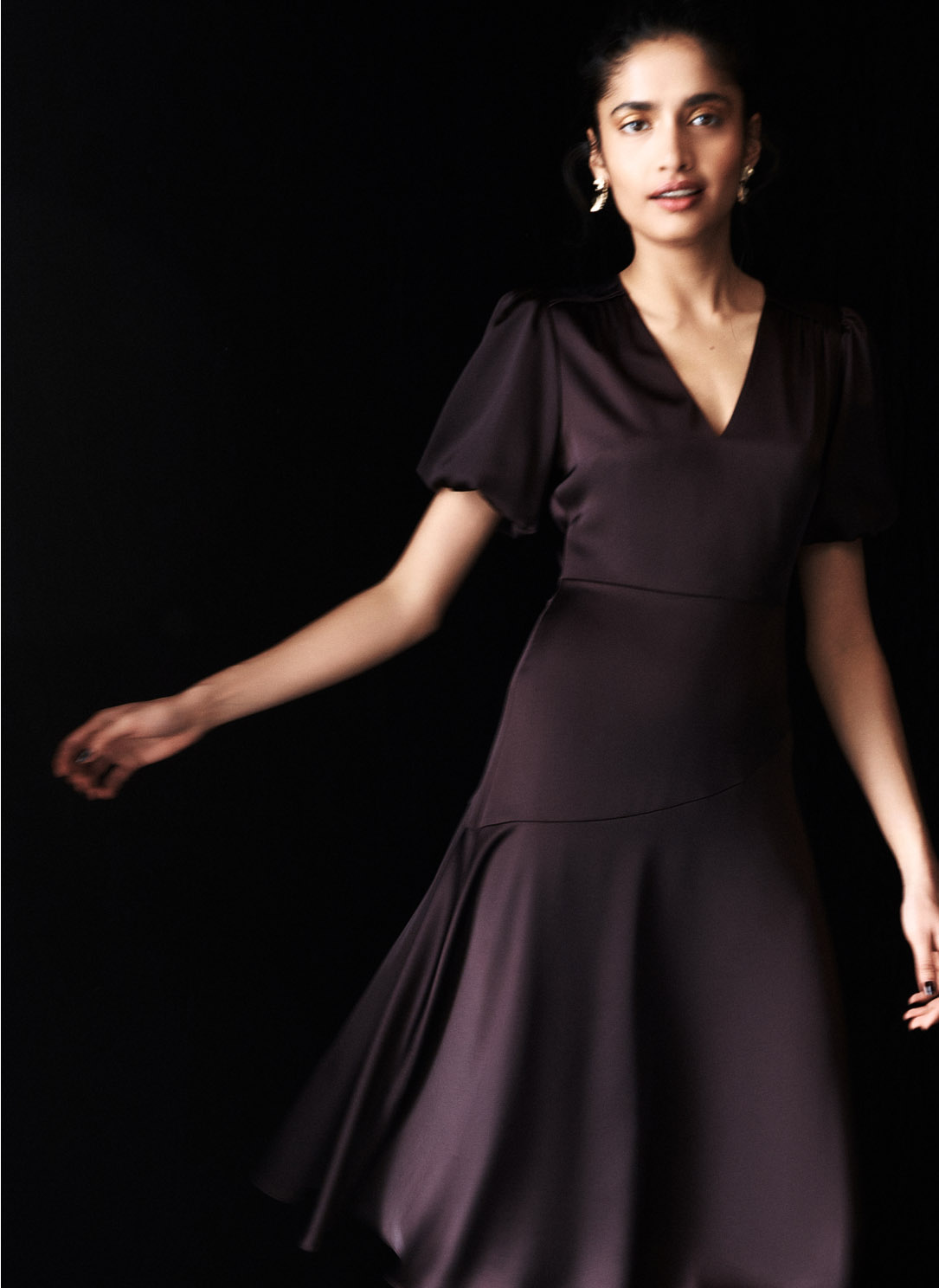 Model photographed in brown dress.