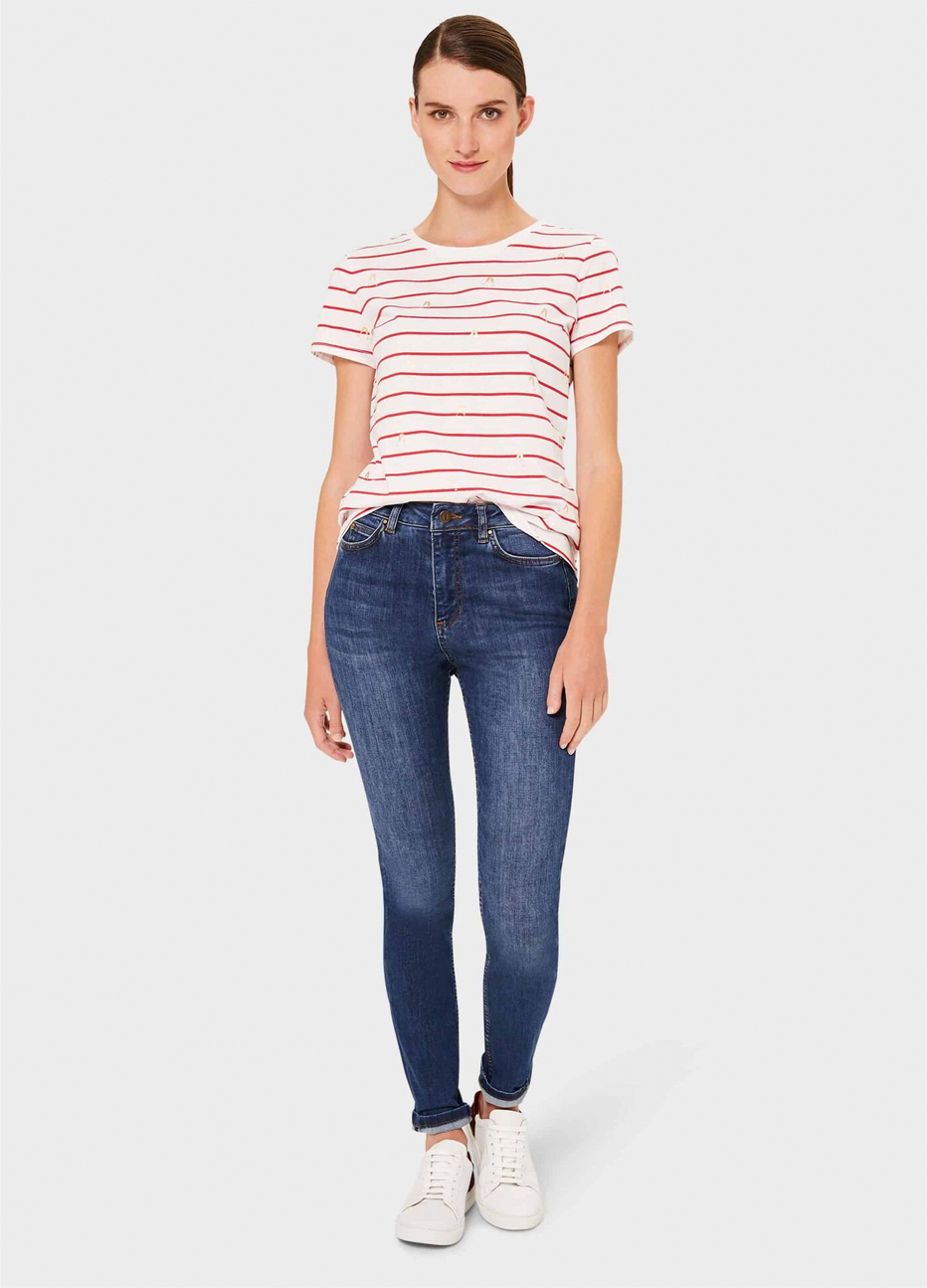 White tshirt with red stripes styled with blue denim jeans and white trainers by Hobbs.