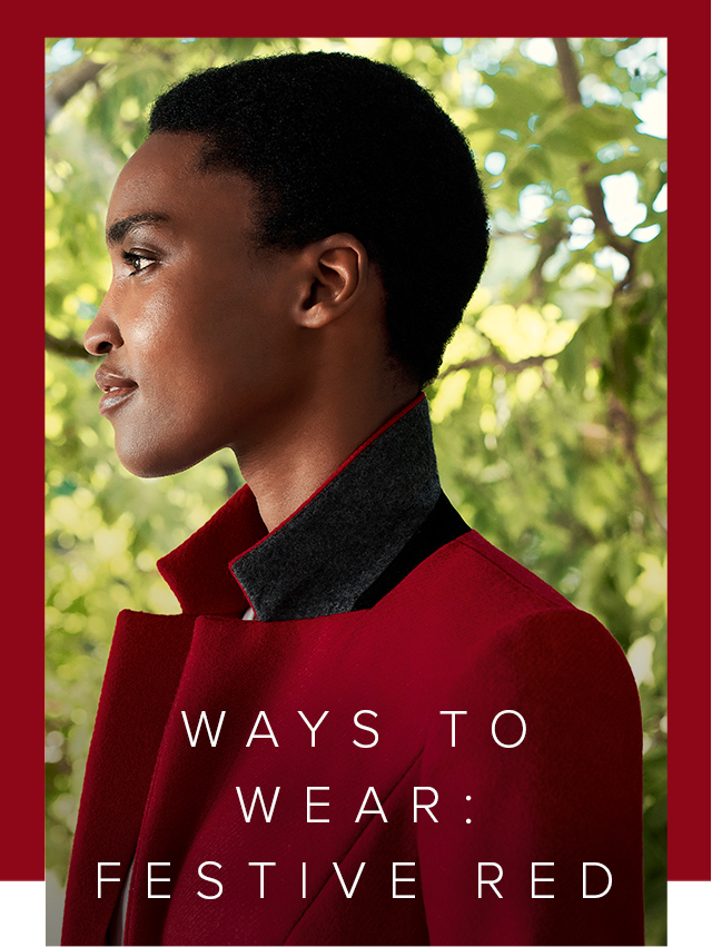 Close-up image of model wearing a Hobbs red jacket with the collar turned up.