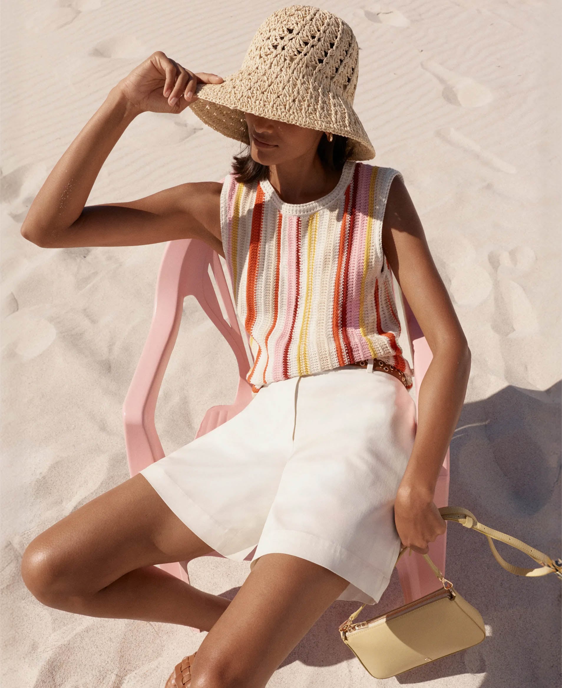 A woman wearing a Hobbs straw bucket hat.
