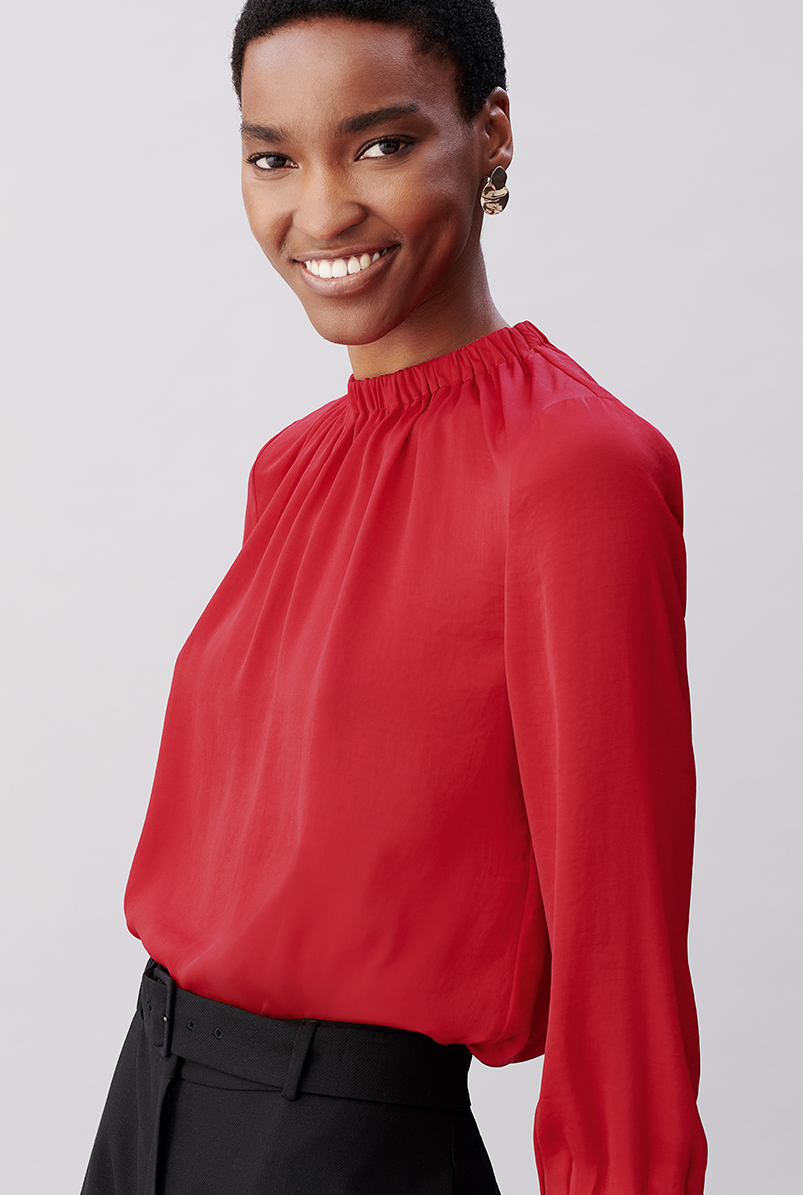 Close-up image of model wearing a Hobbs red blouse.