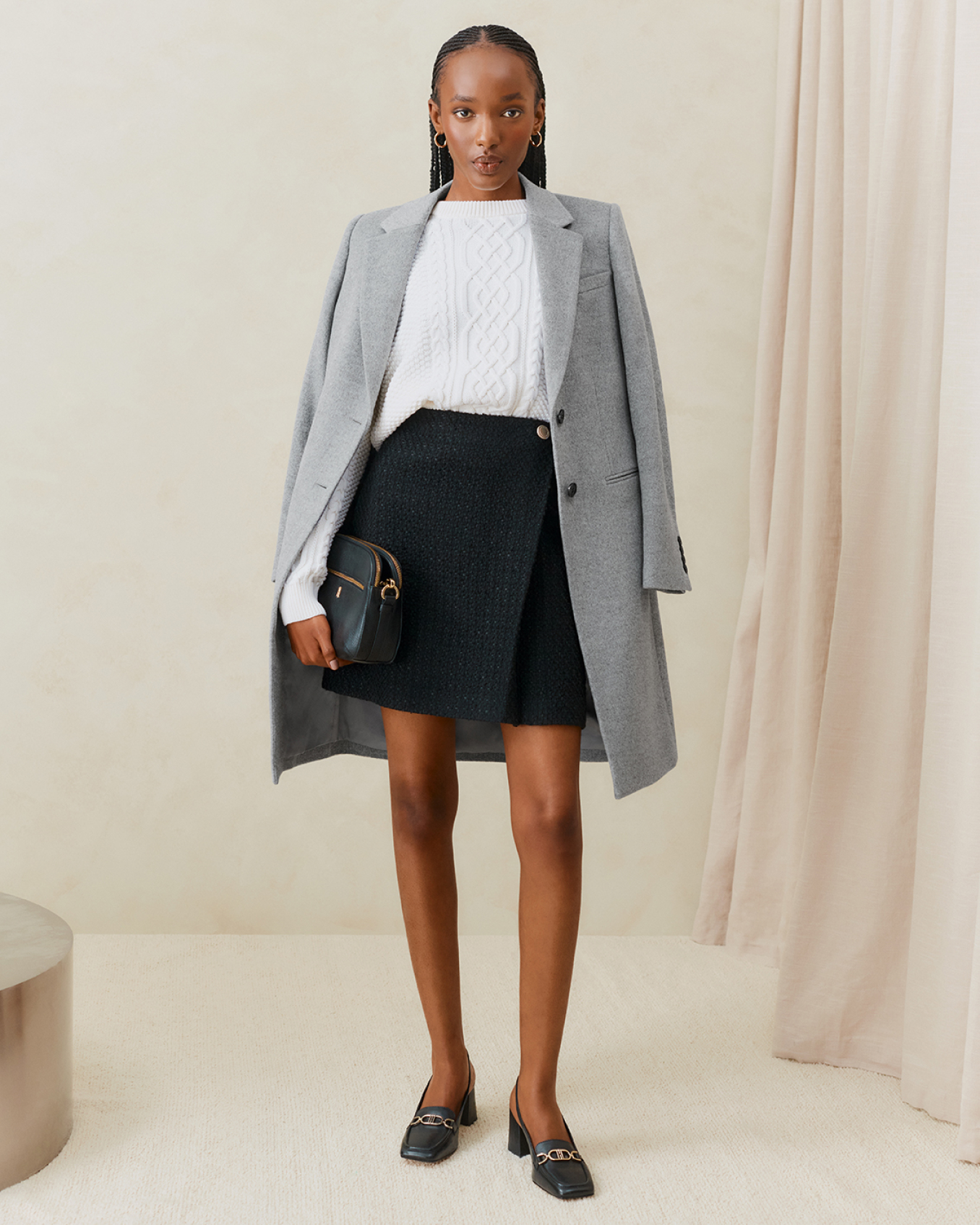 Hobbs model wears a grey tailored coat with a jumper and skirt