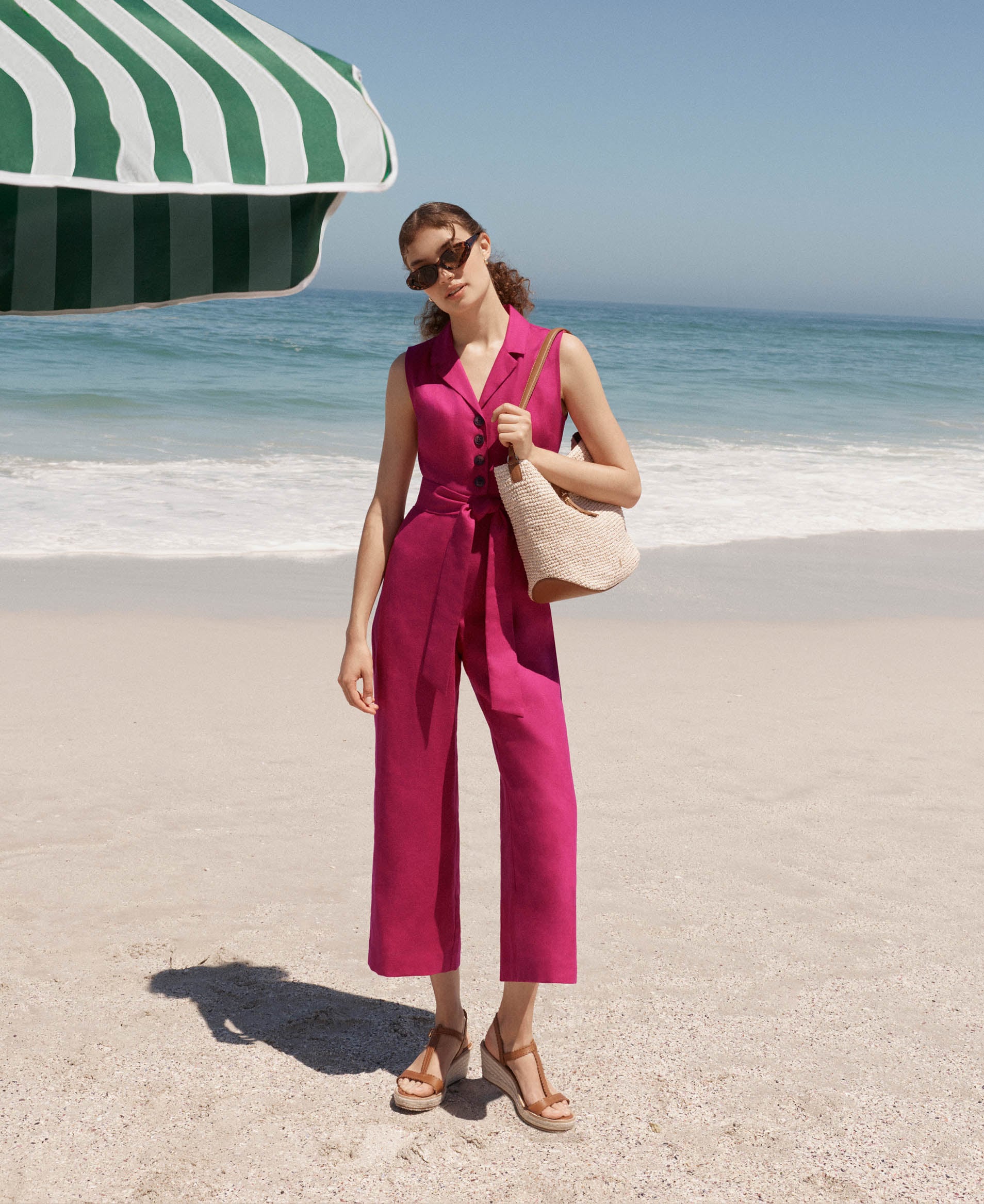 A woman wearing a Hobbs linen jumpsuit.