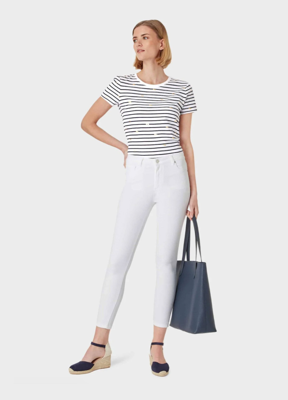 Striped t-shirt in black and white paired with white skinny slim fit jeans, espadrille wedges in black with an ankle strap detail and a black leather tote bag, ideal as a smart casual outfit. Hobbs.