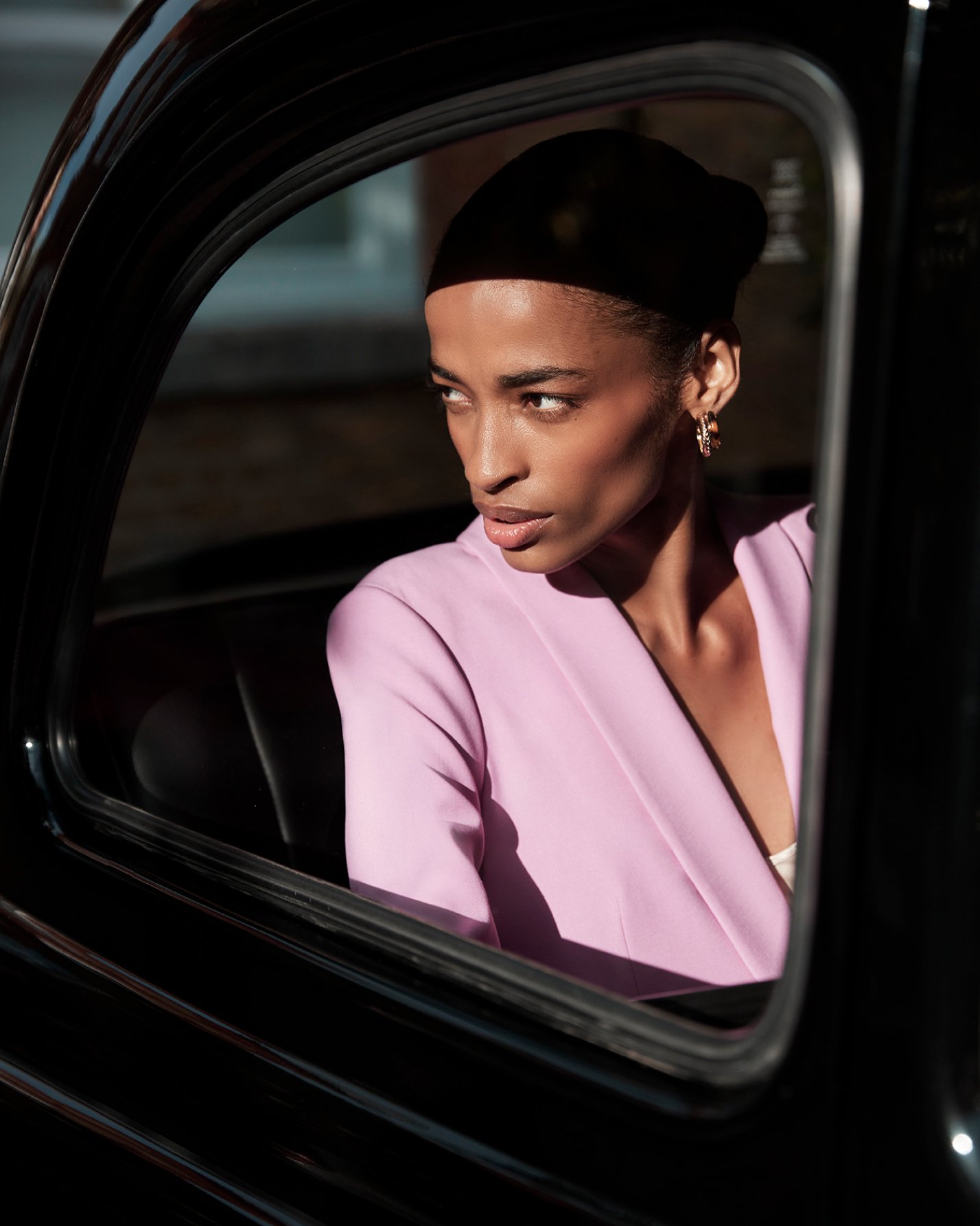 Hobbs model wears a contemporary pink suit with matching accessories.