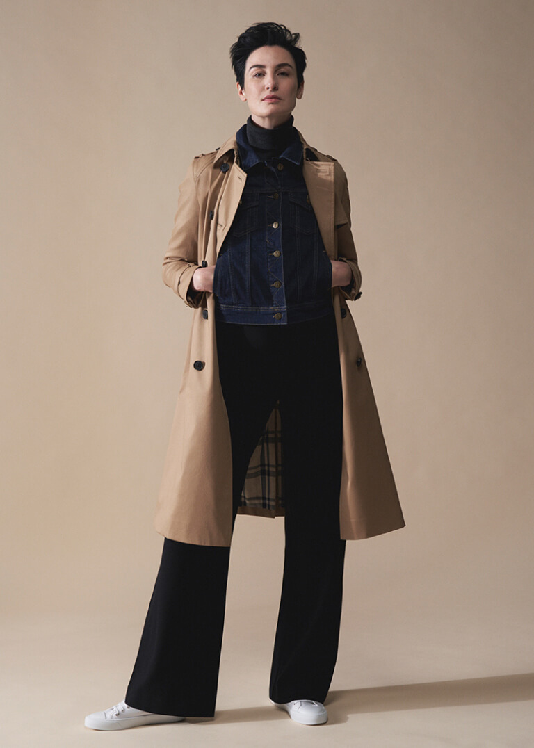 Model Erin O'Connor photographed wearing a Hobbs trench coat over a denim jacket and roll neck jumper.