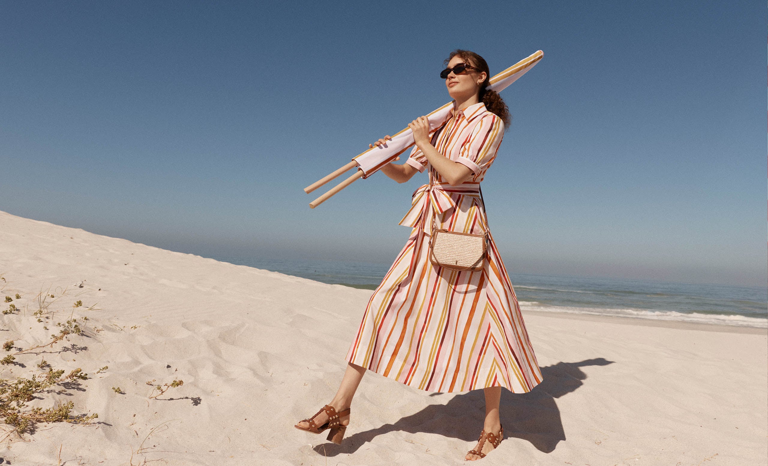 A woman wearing a Hobbs striped shirt dress