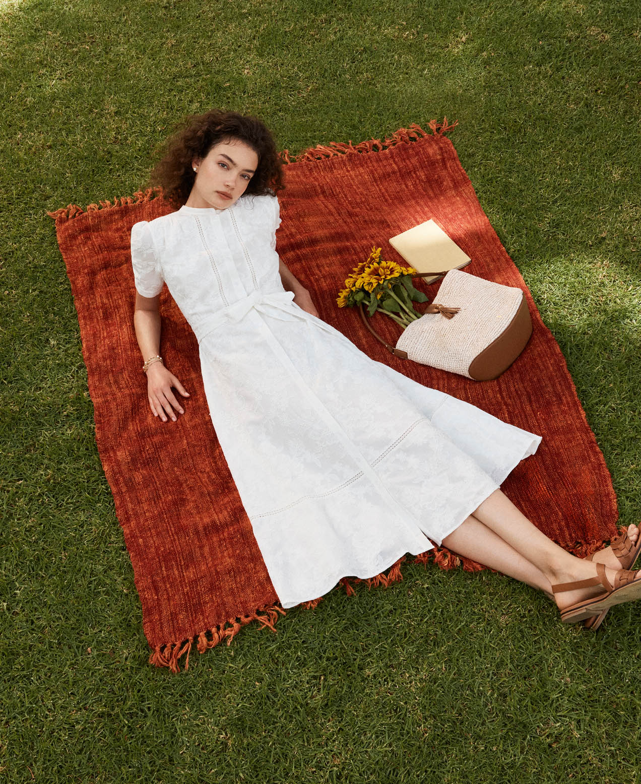A woman wearing a Hobbs white summer dress