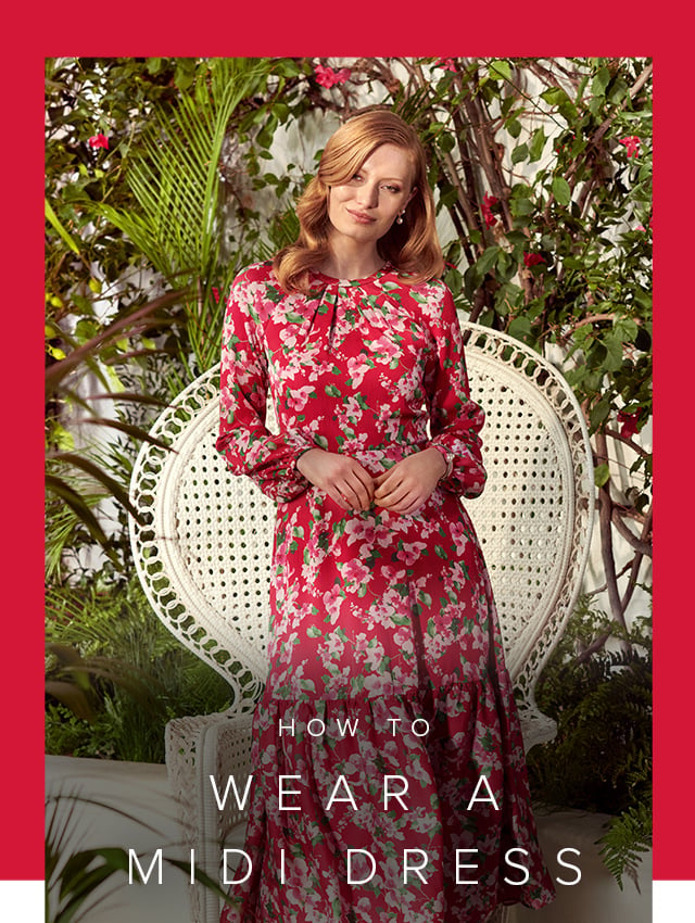 Photographed next to a contemporary armchair, model wears a printed fit and flare linen dress.