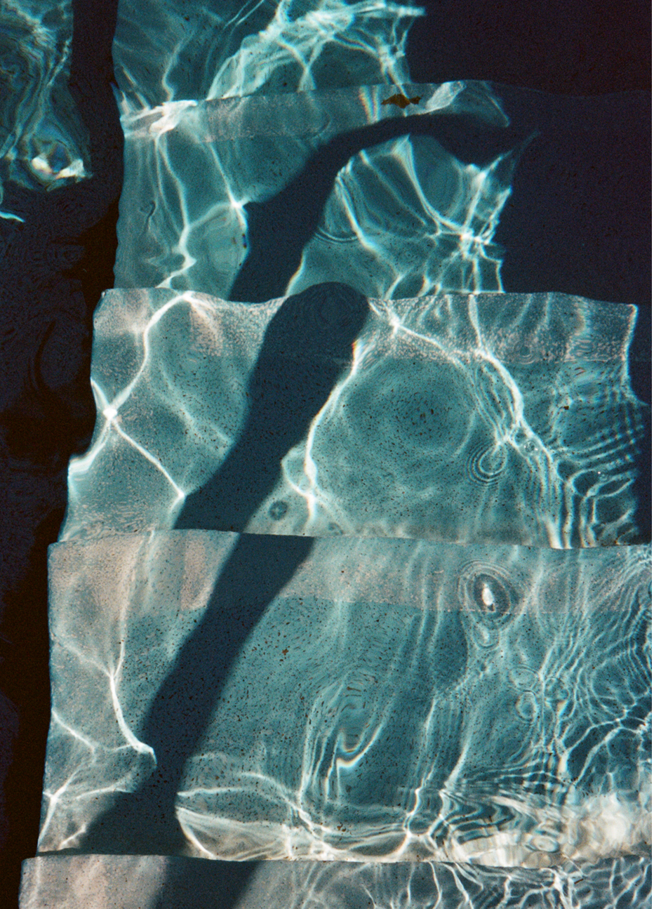 Photograph of steps into a pool with sunlight on the water, captured by photographer Charlotte Bland.