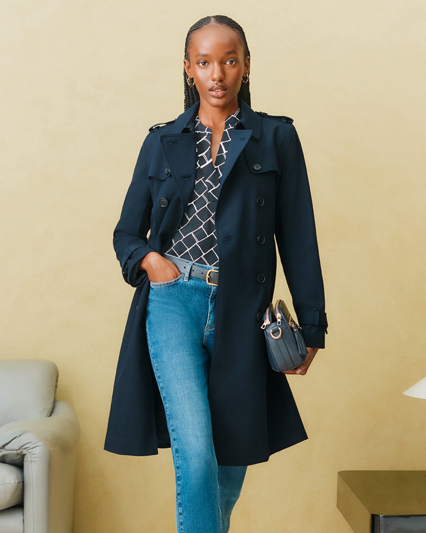 Hobbs model wears a navy blue trench coat