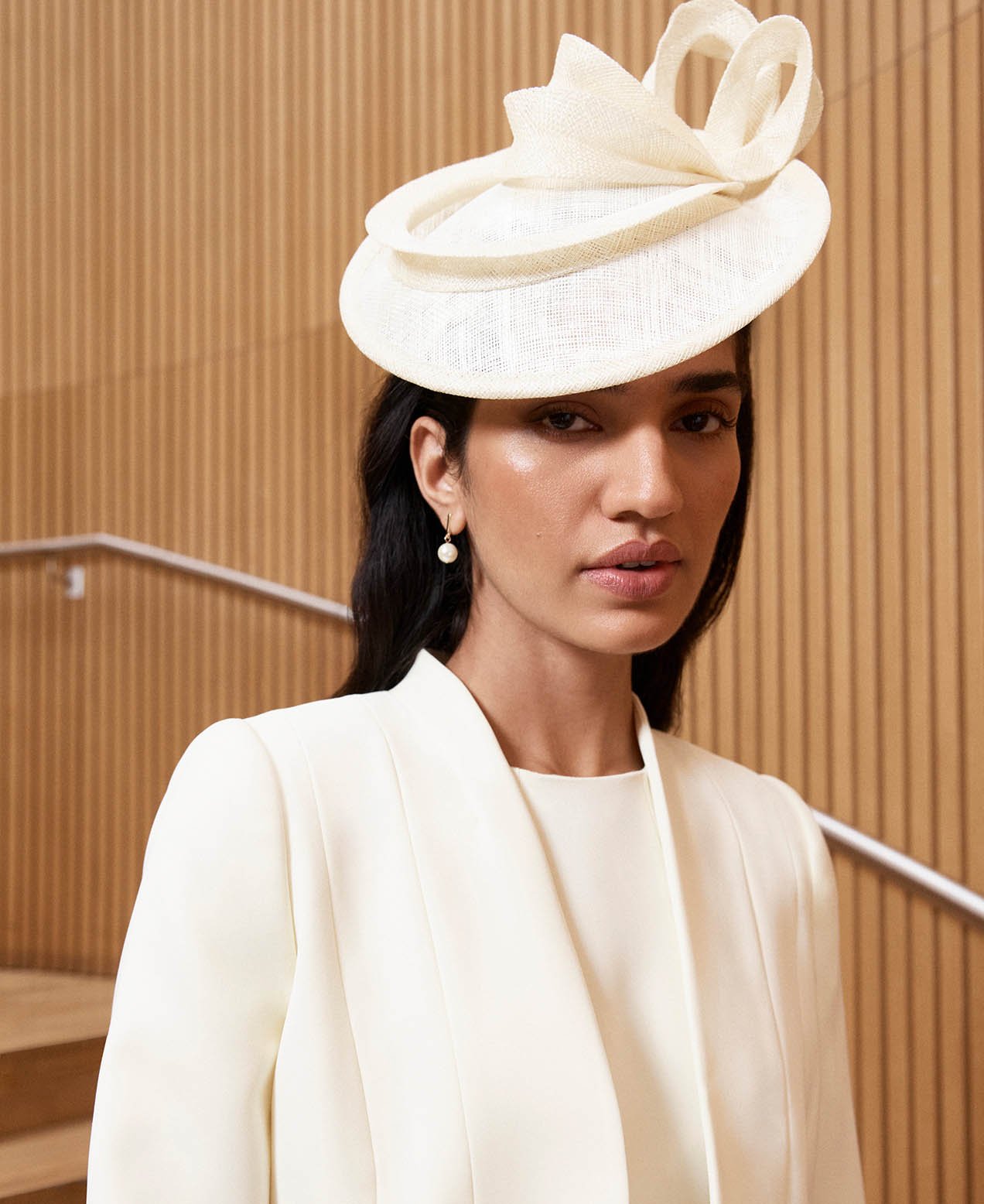 A woman wearing an occasion outfit in head-to-toe butter yellow.