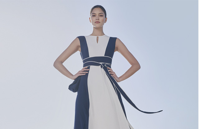 Fit and flare occasion dress in white and navy with a waist tie detail paired with espadrille sandals in navy, by Hobbs.