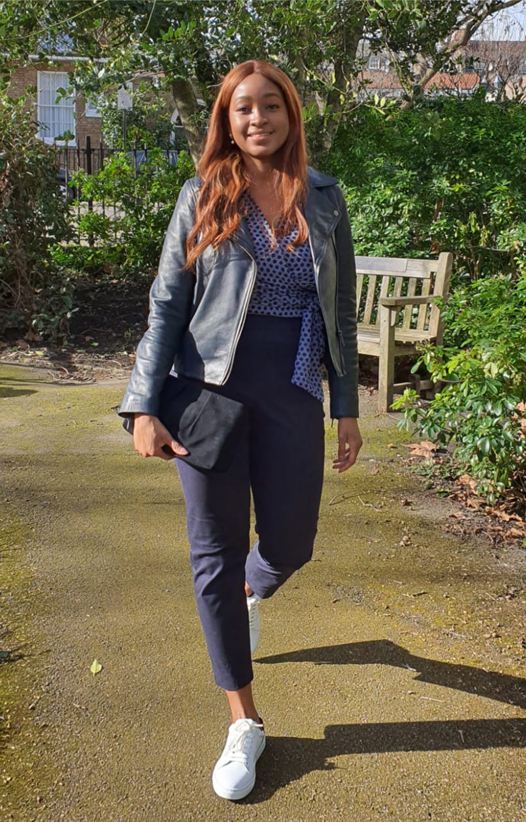 Fashion blogger @rufaro_styling photographed on a walk wearing Hobbs Tania navy leather jacket, Elizabeth Blouse and Yasmin capri trousers.