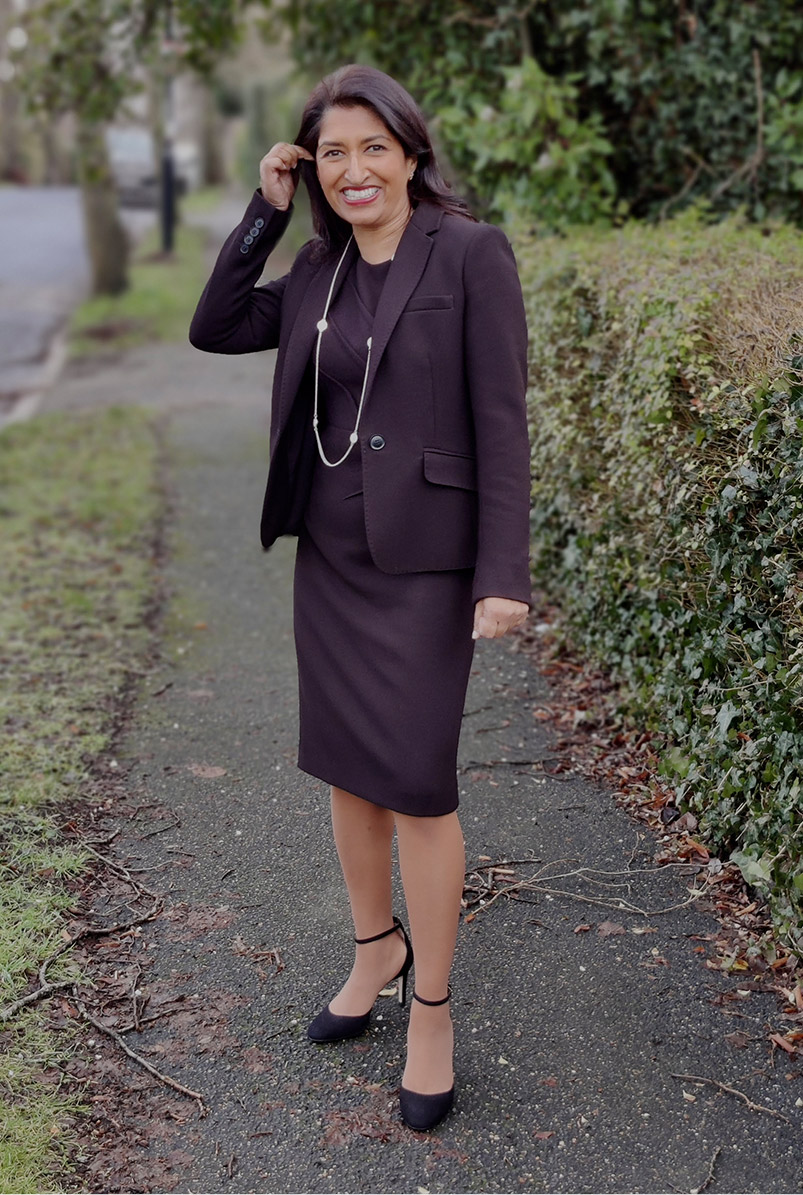 Photographed walking along her street, fashion blogger Monika Mandal wears Hobbs petite Ophelia black jacket and matching dress.