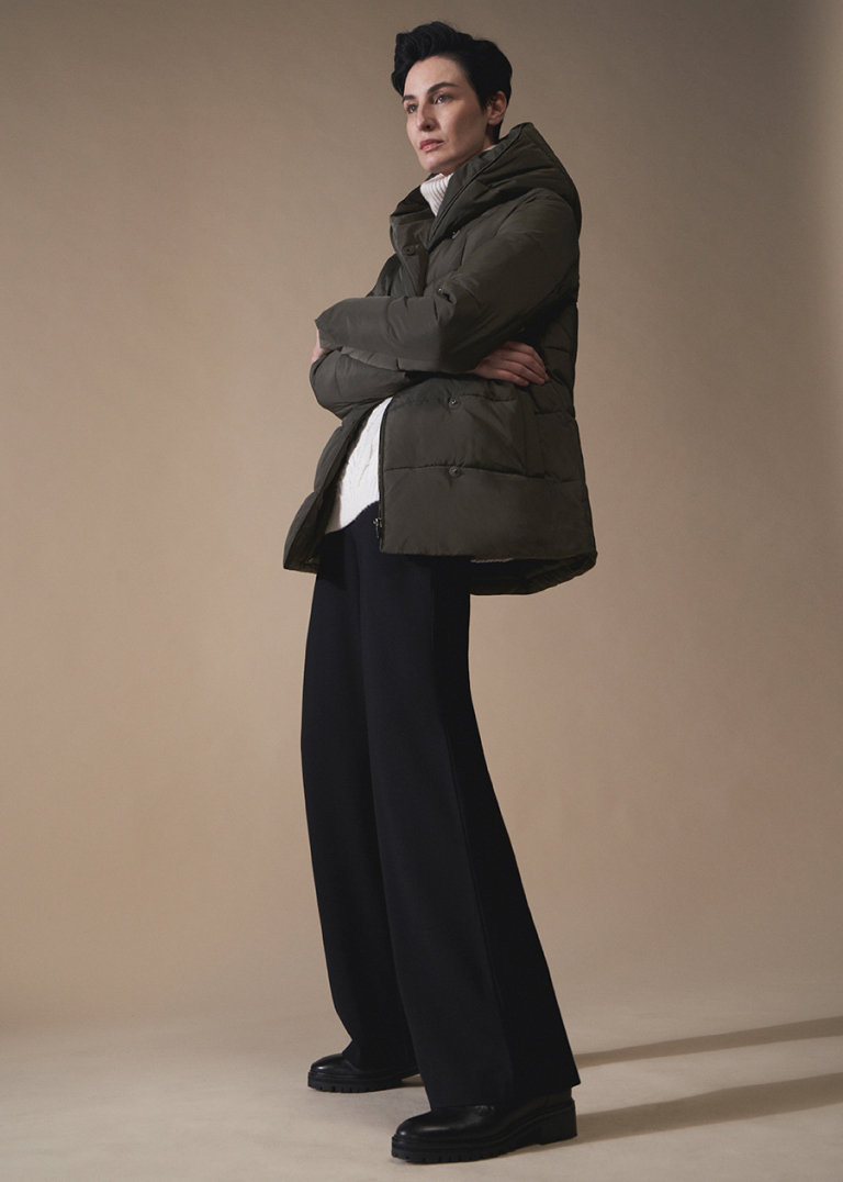Model Erin O'Connor photographed wearing a Hobbs puffer jacket and wide leg trousers.