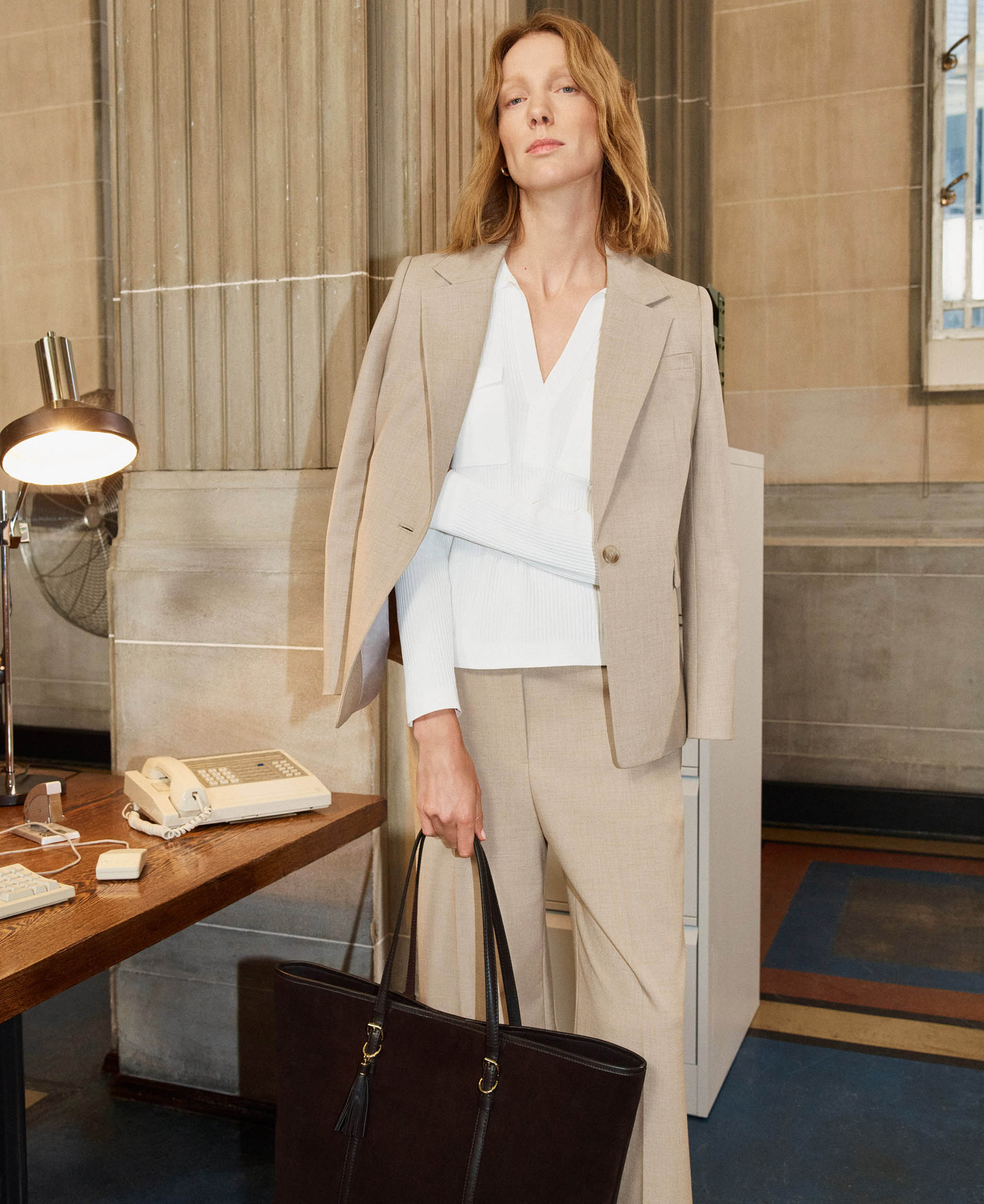 A woman wearing Hobbs' new Ashleen suit in the office.