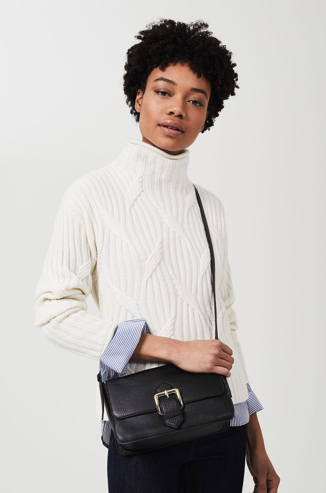 Model photographed wearing Hobbs black leather Selbourne crossbody bag.