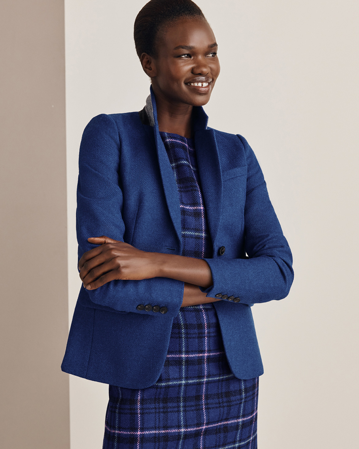 Hobbs model wears a wool blazer over a heritage check dress.