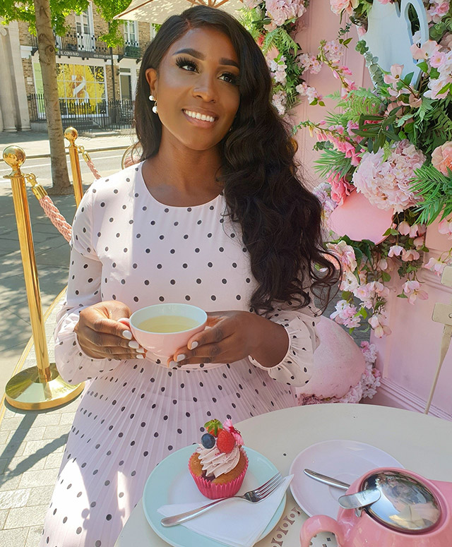 Image consultant woman_ofelegance photographed at a cafe wearing Hobbs' Selena pink polka dot dress.