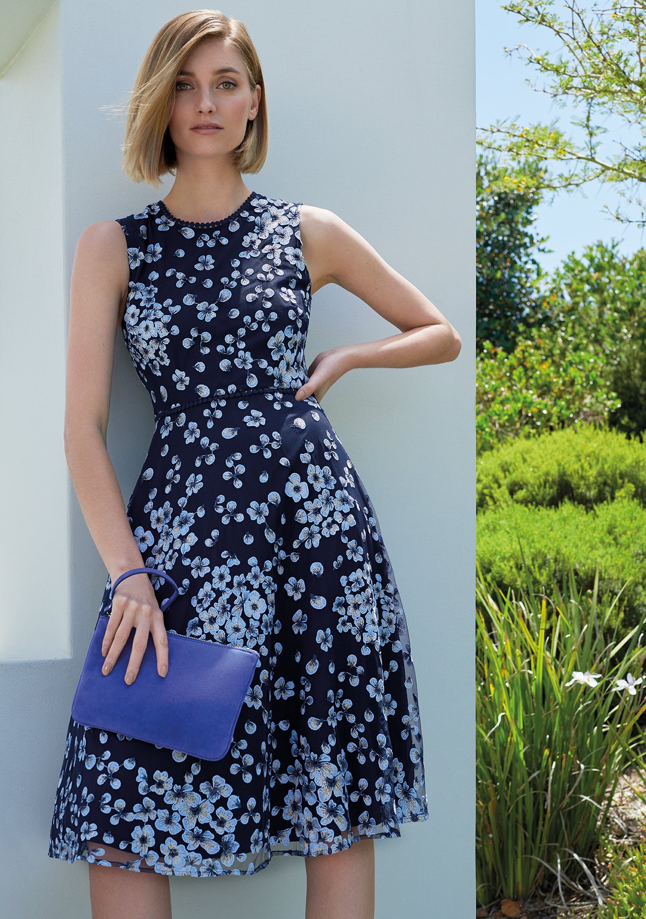 Floral occasion dress in dark blue with matching clutch by Hobbs.