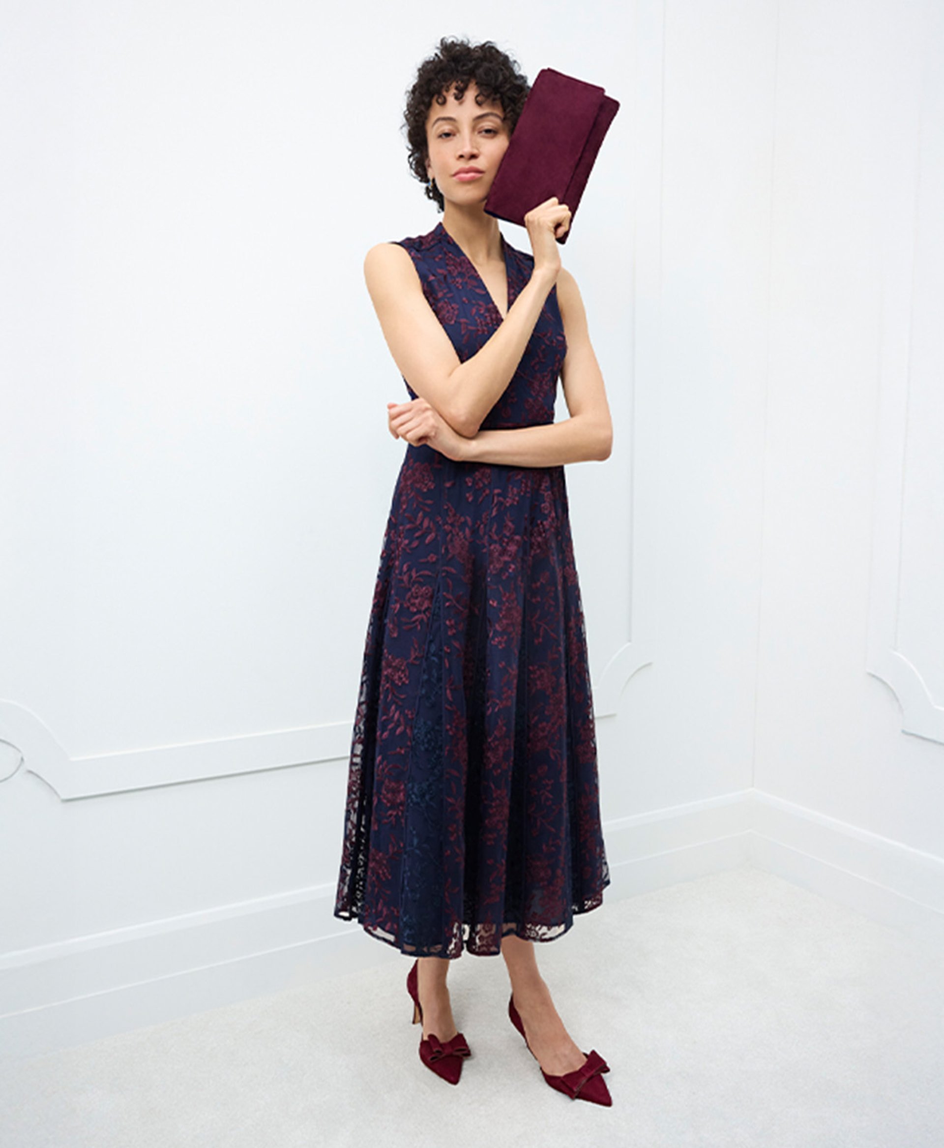 A woman wearing an embroidered Hobbs occasion dress
