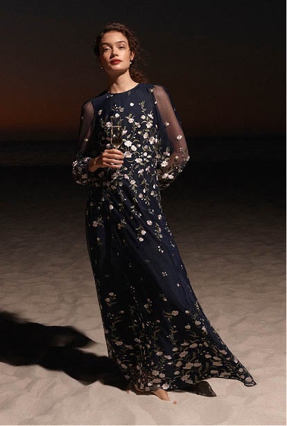 A woman wearing an embroidered Hobbs Black Tie dress.