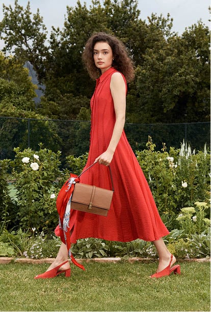 A woman wearing a red Hobbs shirt dress.