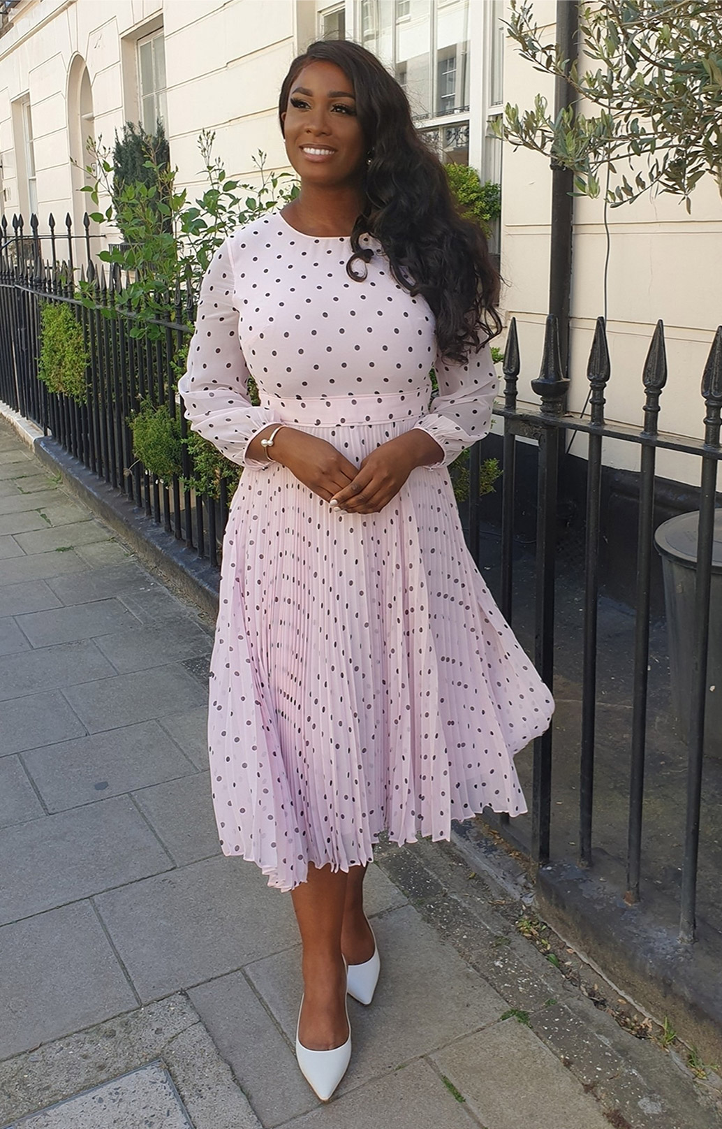 Fashion blogger @woman_ofelegance photographed at a cafe wearing Hobbs' Selena pink polka dot dress.