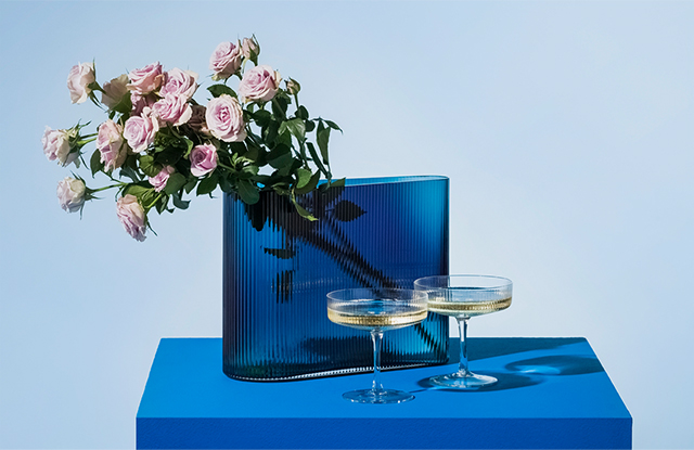 Spruce Up your fizz with two champagne coupes styles with a cobalt blye vase and dusky pale pink roses