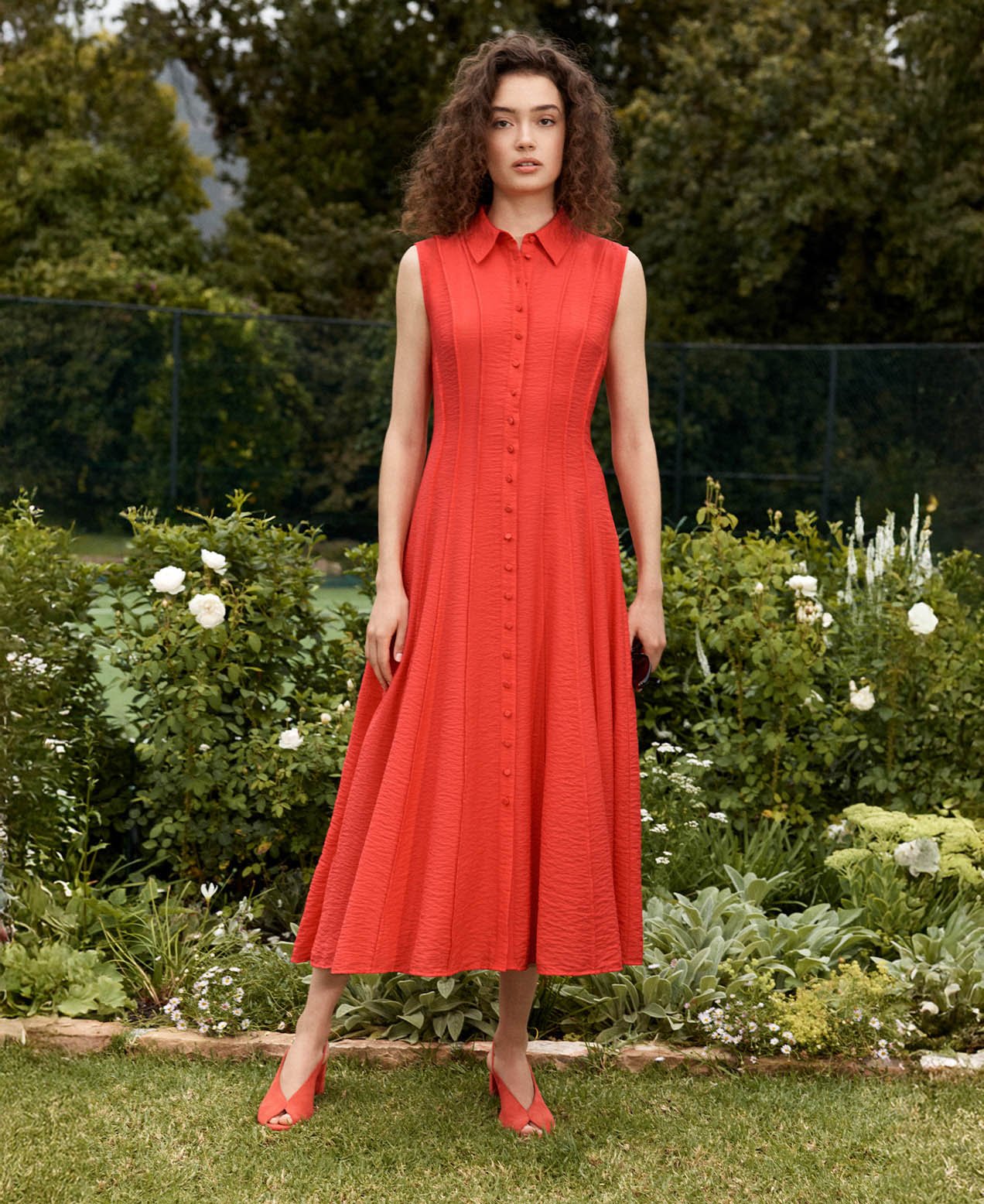 A woman wearing a red Hobbs shirt dress.