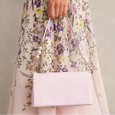 A woman wearing a blush pink occasion outfit.