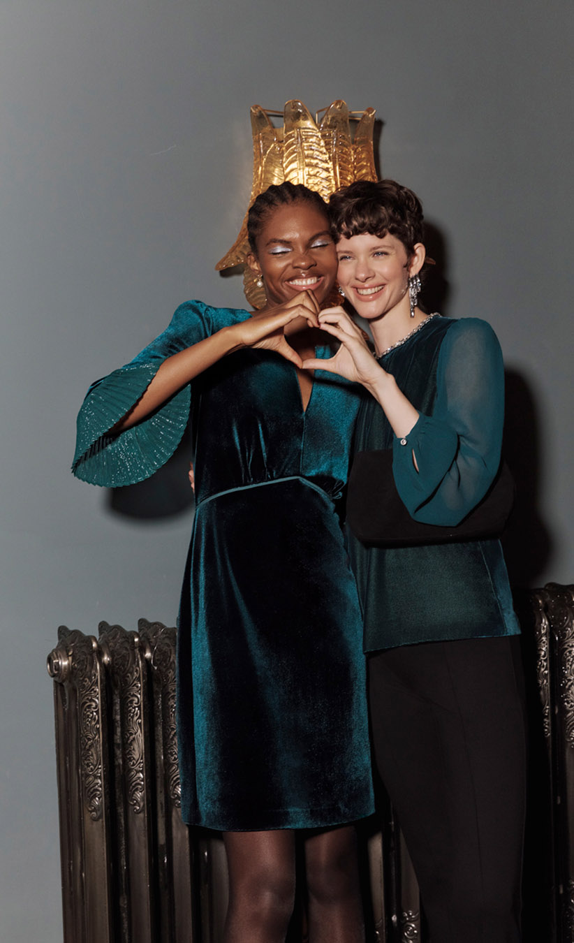 Women wearing chic Christmas party looks in jewel-tone colours.