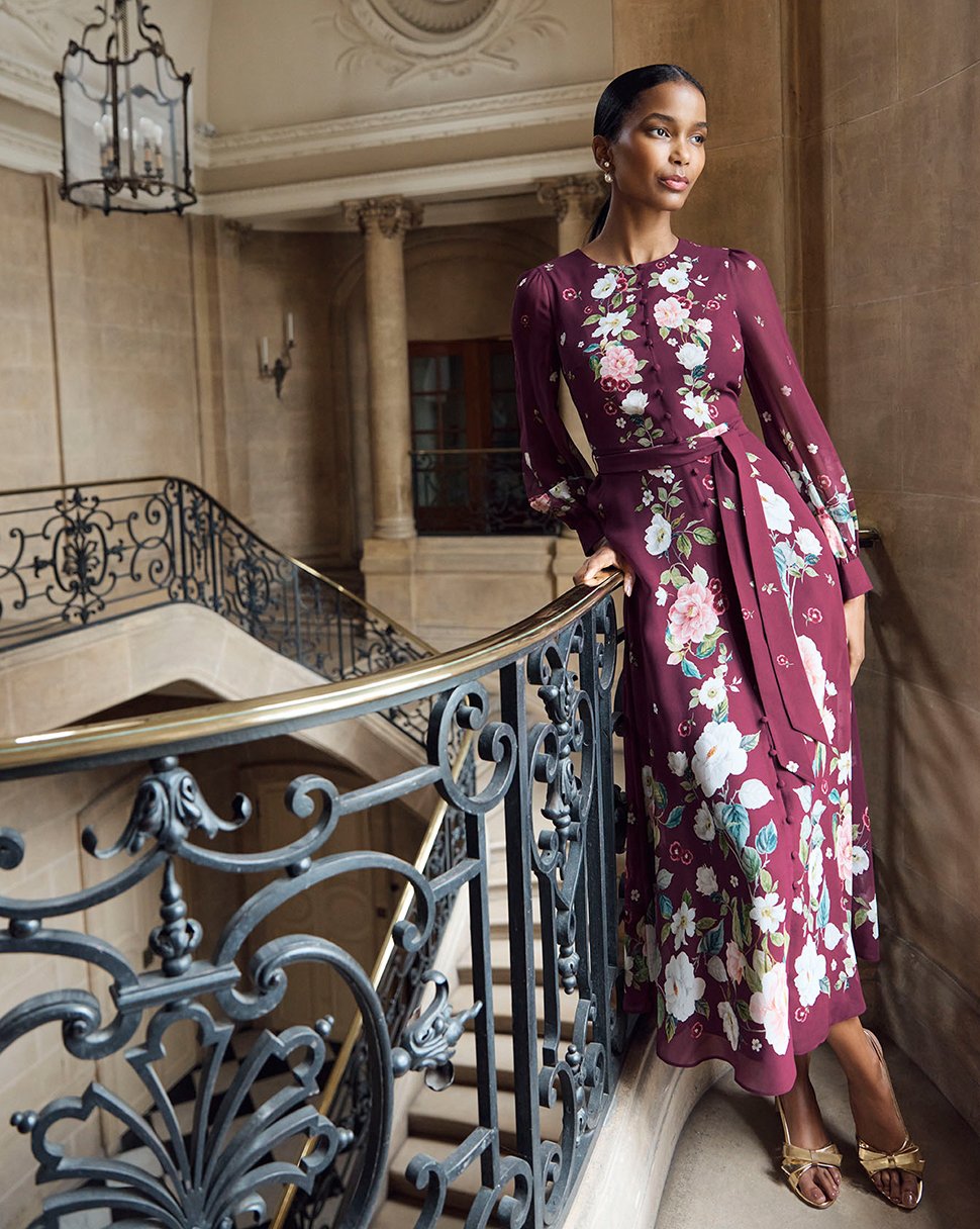 Hobbs model wears a floral print silk midi dress.