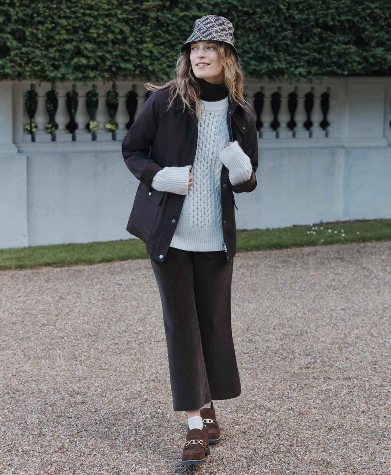 A woman wearing Hobbs coats and jackets.