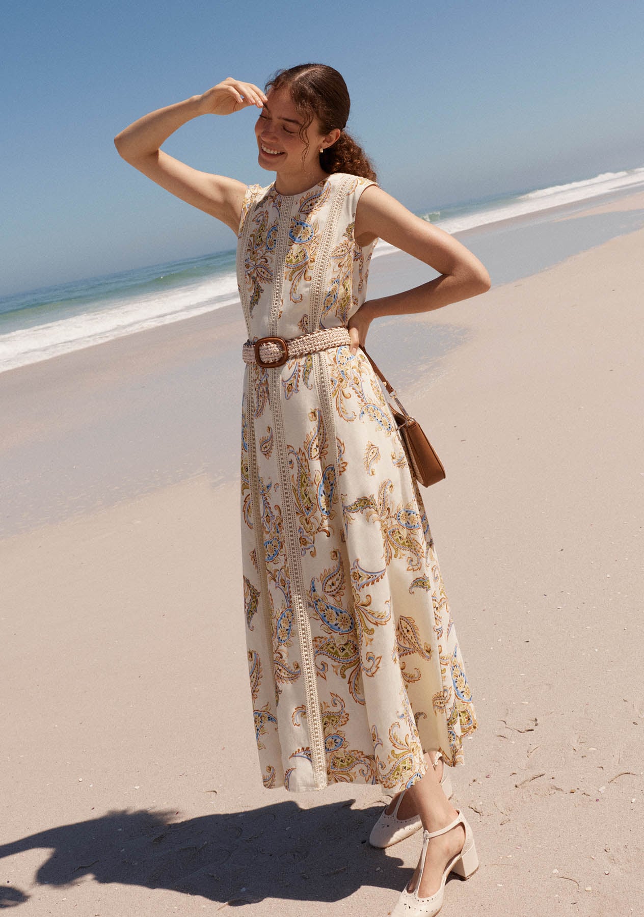 A woman wearing a Hobbs linen paisley dress.