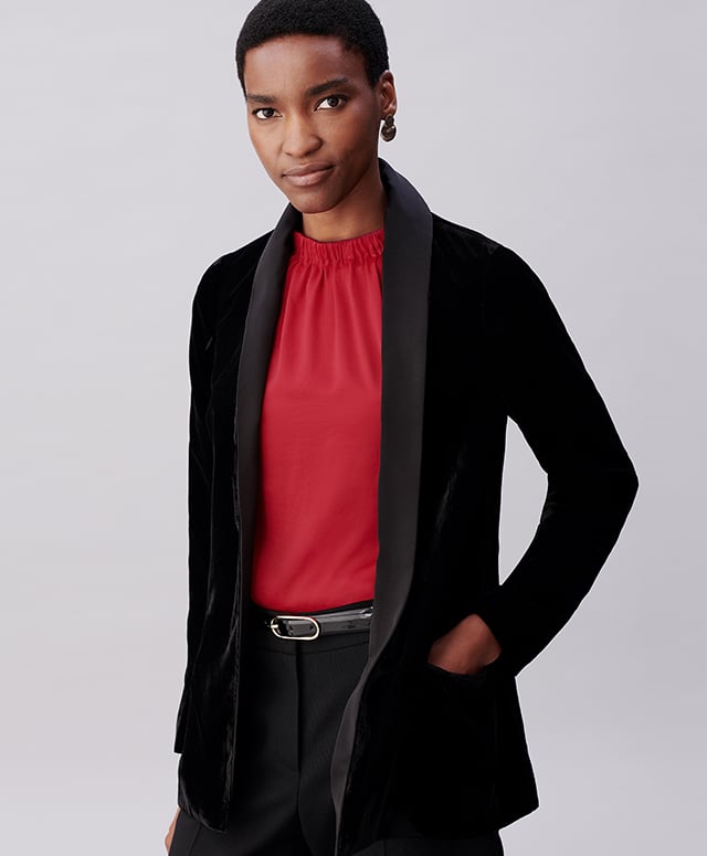 Model photographed wearing a black velvet jacket over a metallic thread shirt dress.