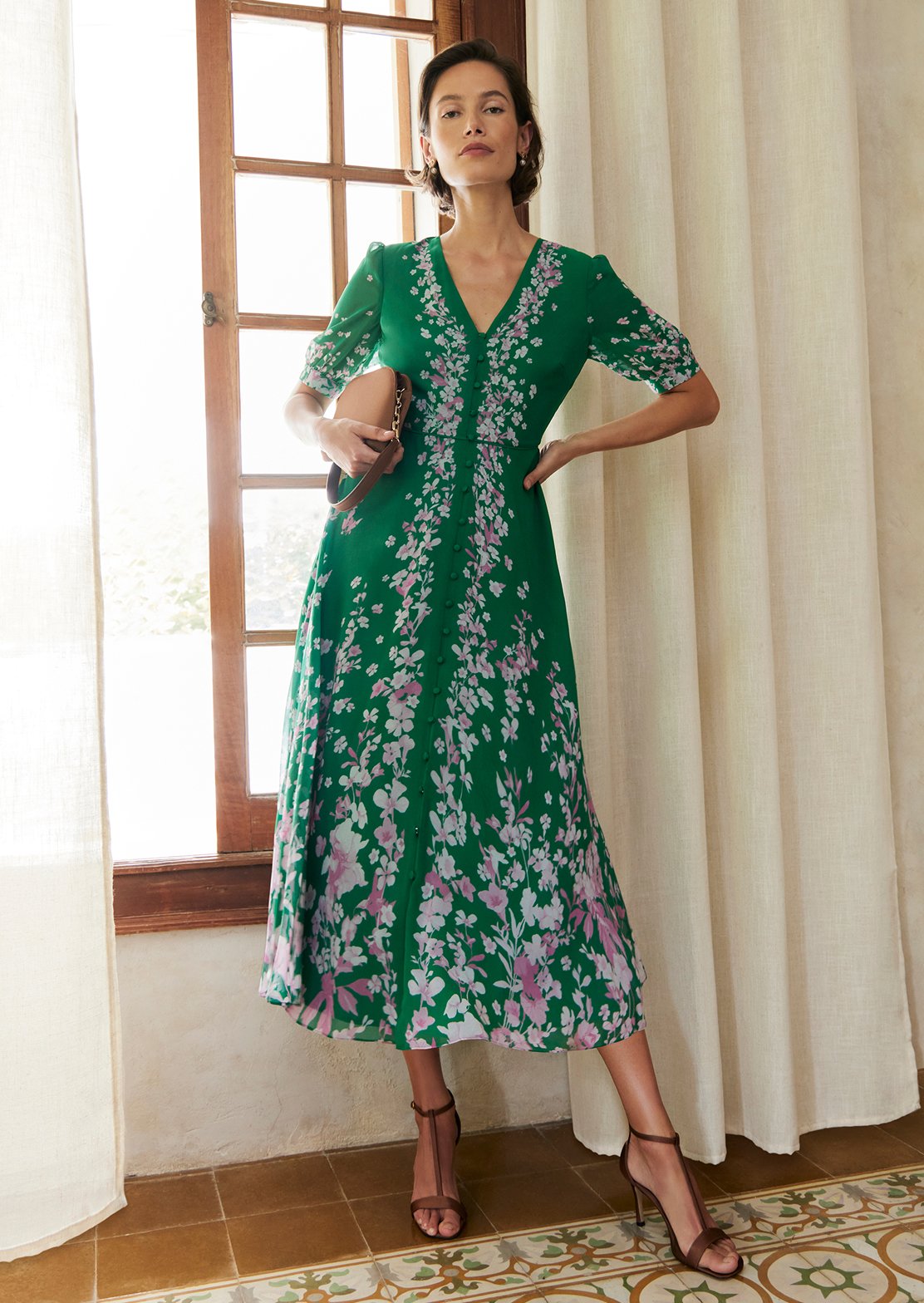 An image of a model wearing a petite Hobbs floral dress.