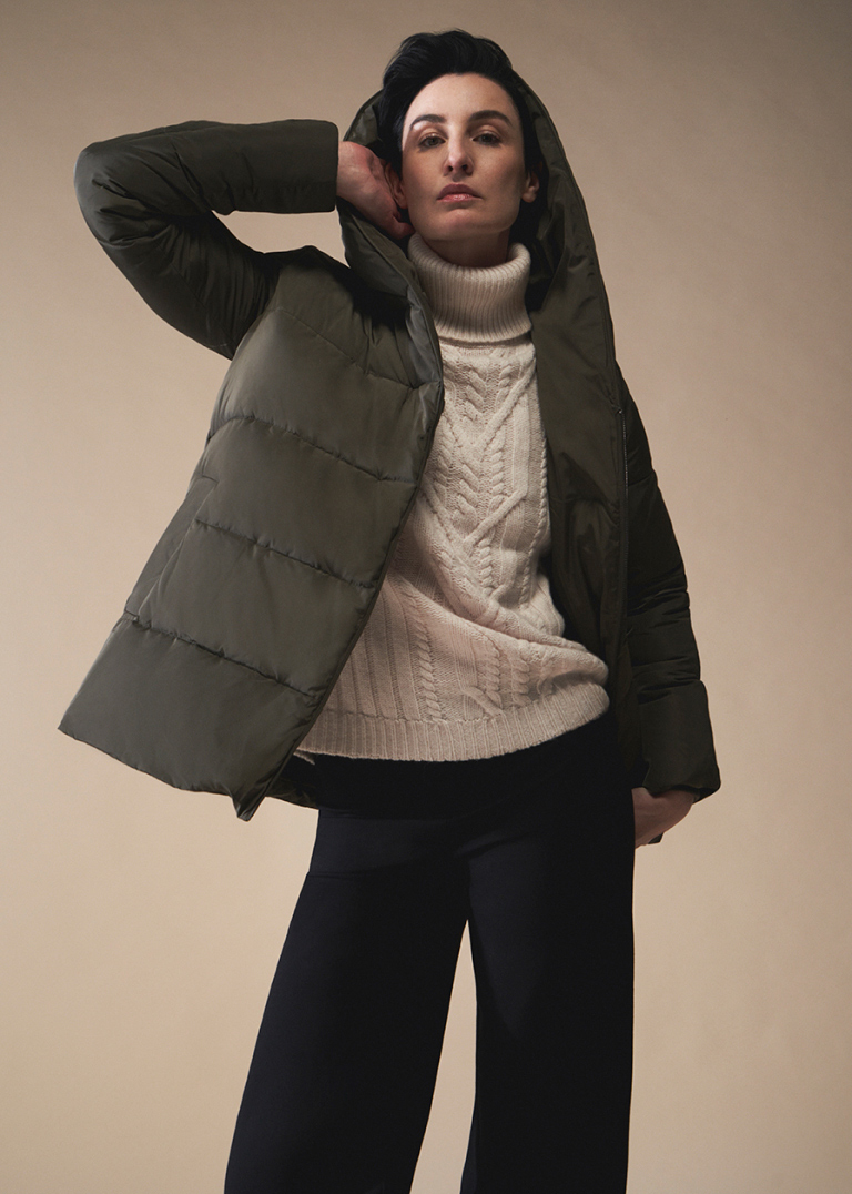 Model Erin O'Connor photographed wearing a Hobbs puffer jacket over a cable knit jumper.