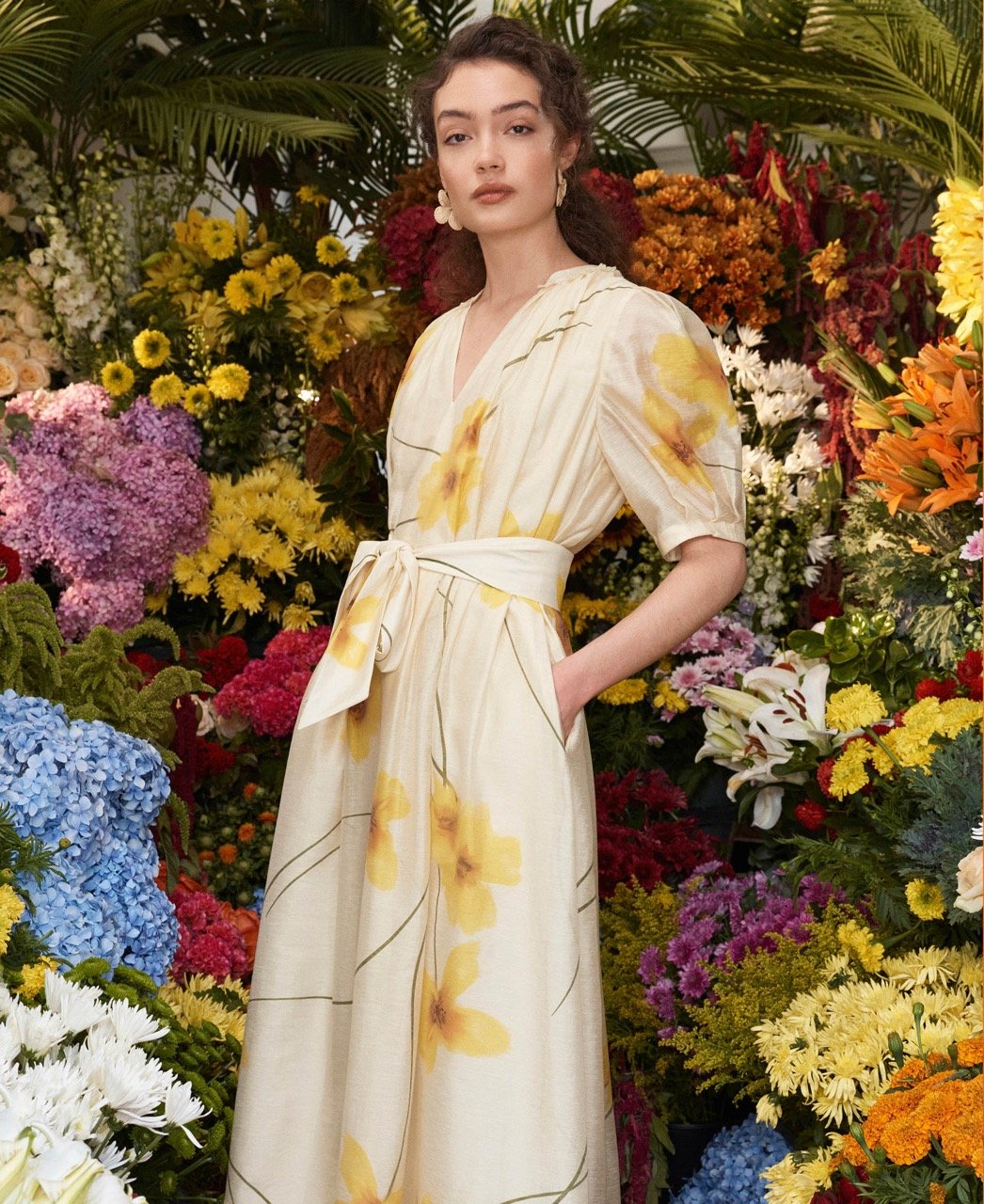 A woman wearing a navy occasion dress.