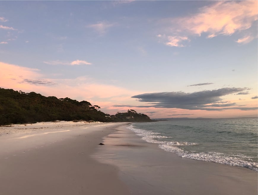 A serene beach scene with a pink and blue sky is evoked by Kavery Musgraves, Oh What A World.