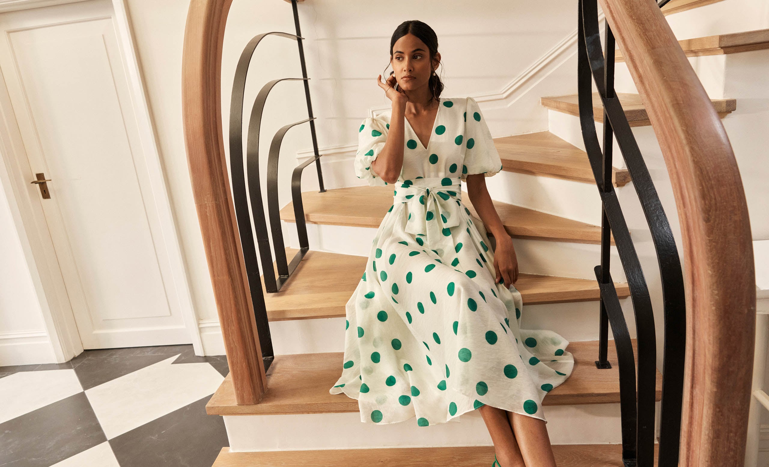 A woman wearing a Hobbs polka dot dress.