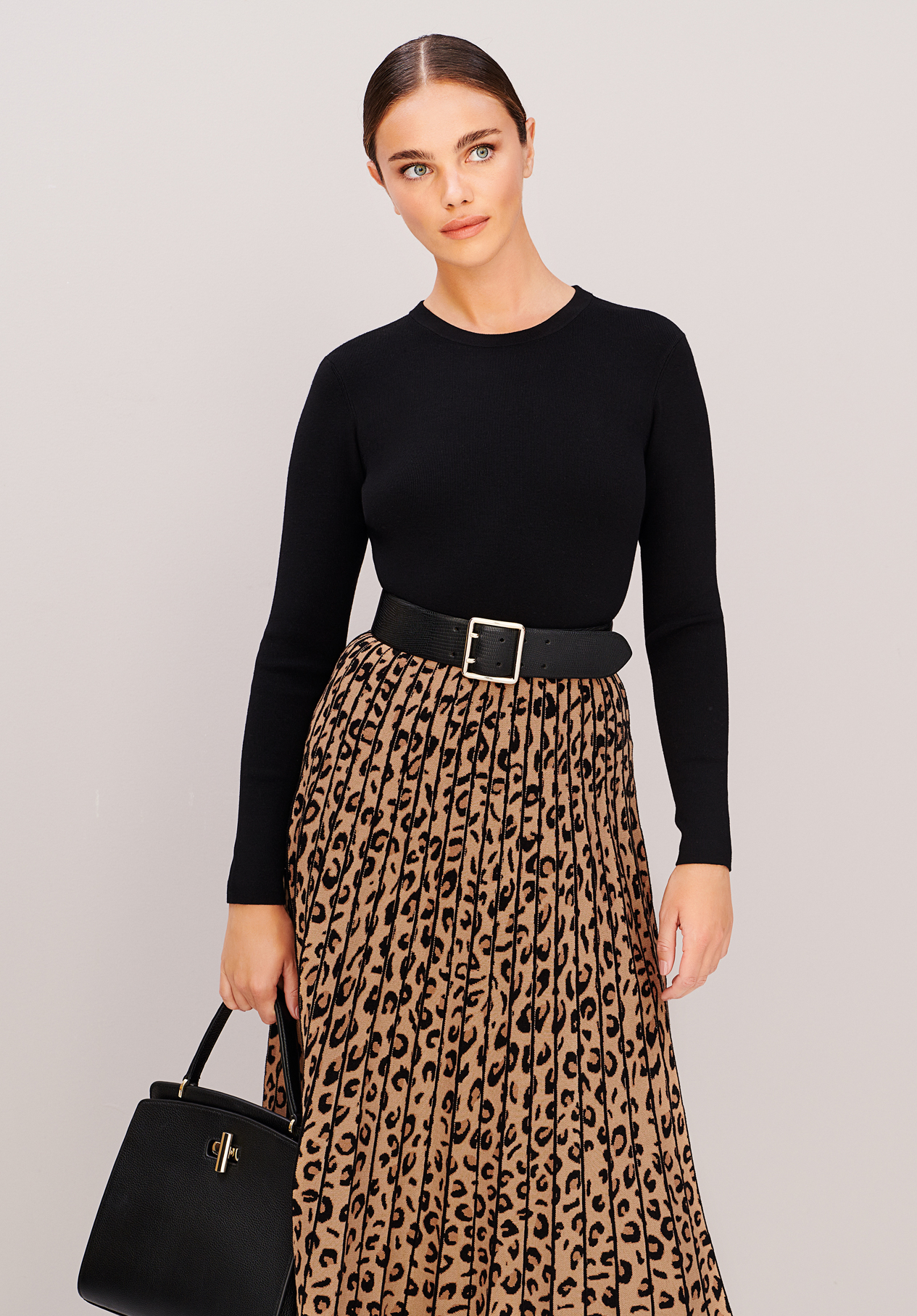 Model wears a knitted leopard print dress with a belt from Hobbs.