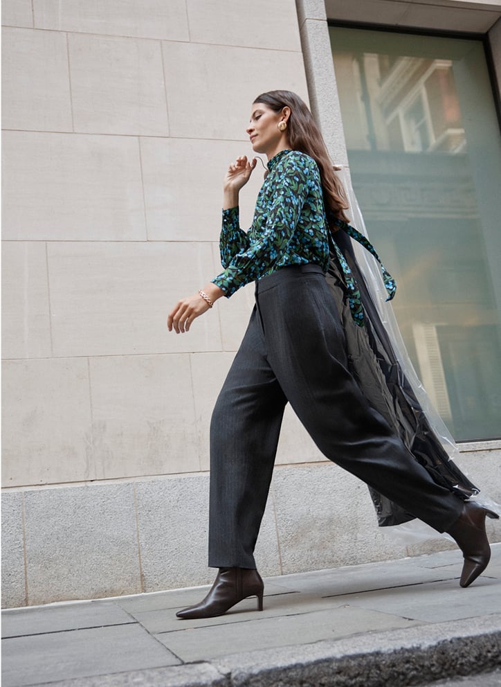 Model photographed in grey trousers.