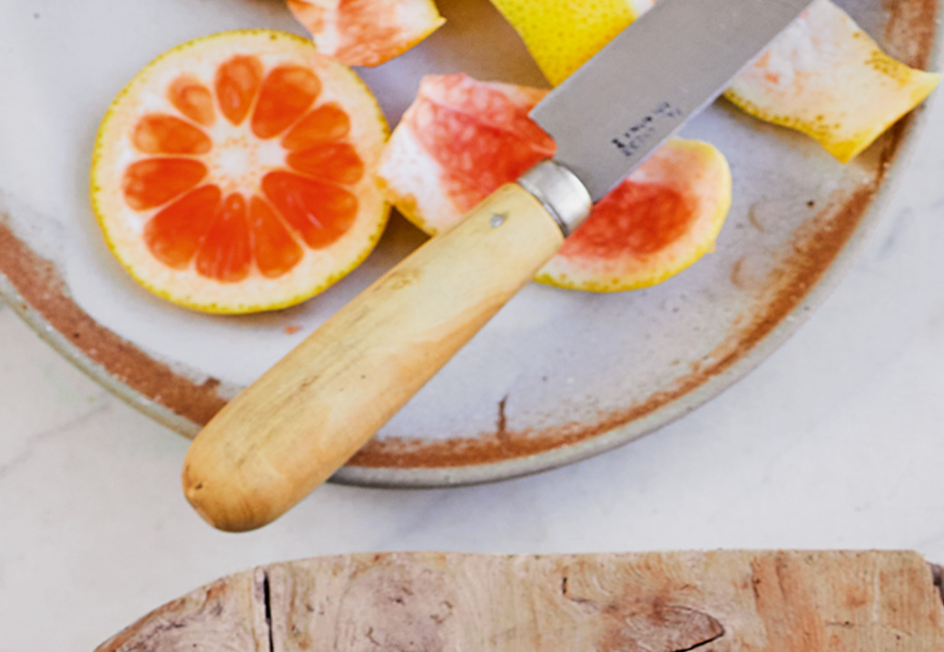 A sliced grapefruit on a plate