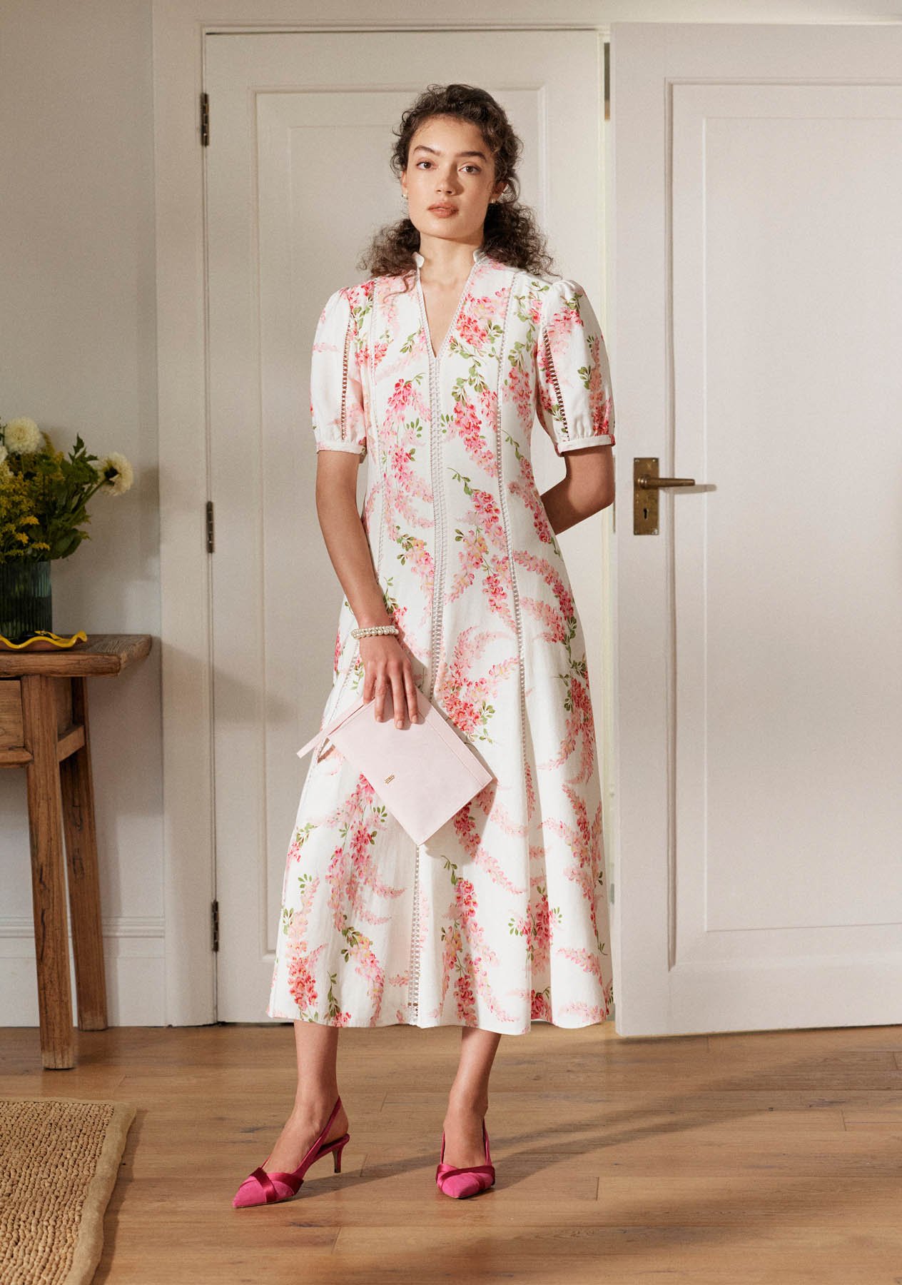 A woman wearing a Hobbs linen occasion dress.