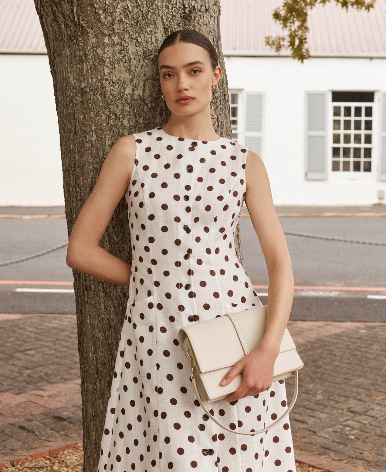 A woman wearing a polka dot linen dress.