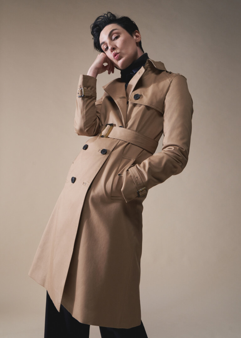 Model Erin O'Connor photographed against a backdrop wearing a Hobbs camel trench coat.
