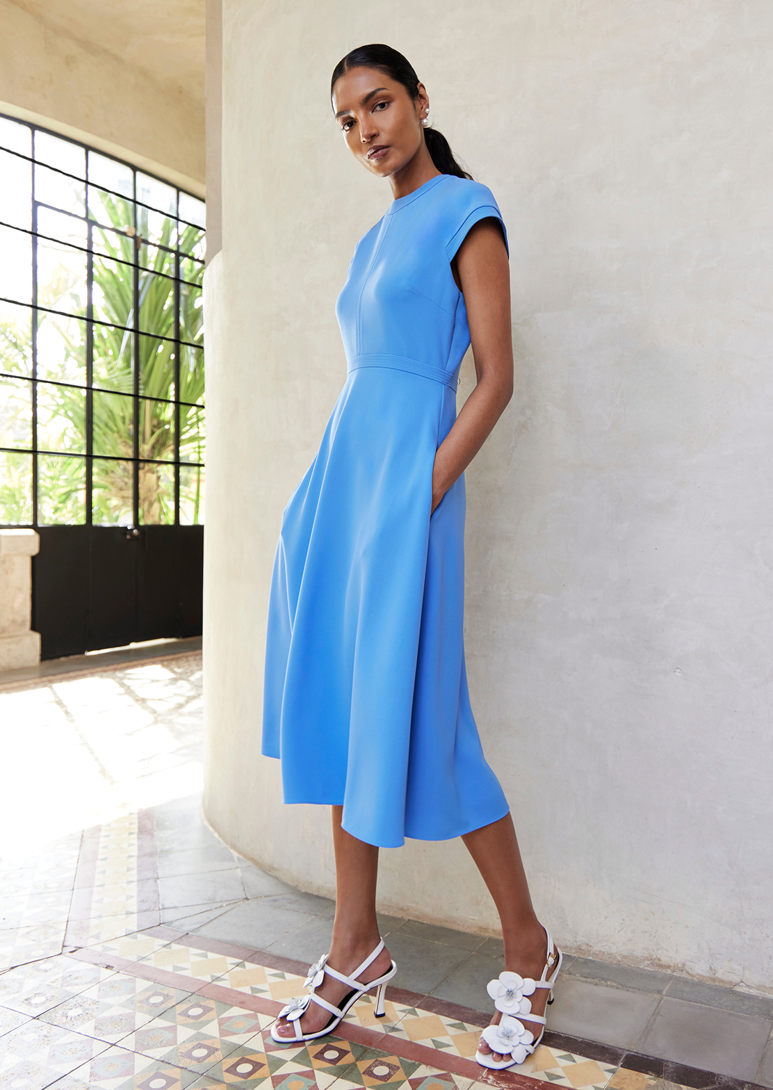 An image of two models wearing Hobbs blue occasion dresses.